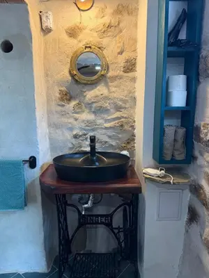 a bathroom sink sitting on a wooden table at Villa Filistrina in Yasna Polyana