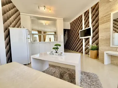 a kitchen with a white table and a refrigerator at Emerald Paradise - Menada Apartments in Sunny Beach