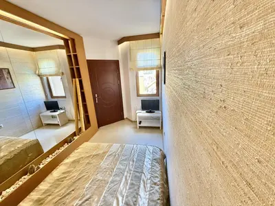 a bedroom with a bed and a large wall at Emerald Paradise - Menada Apartments in Sunny Beach