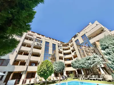 an apartment building with a swimming pool and trees at Emerald Paradise - Menada Apartments in Sunny Beach