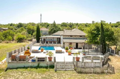 a house with a swimming pool in front of it at Luxury, private pool, sauna, beach! in Banya