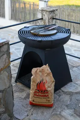 a fire pit with a bag of food next to it at Luxury, private pool, sauna, beach! in Banya