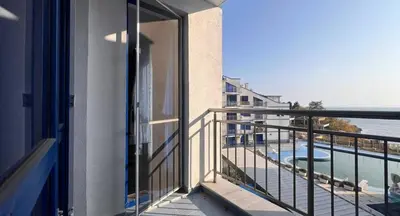 a balcony with a view of a swimming pool at Двустаен апартамент с морска панорама в Blue Bay Palace in Pomorie