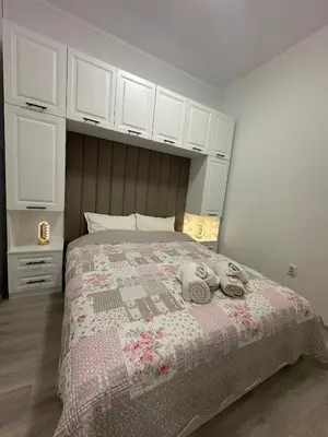 a bedroom with a bed with two stuffed animals on it at Апартамент за нощувки и отдих in Burgas City