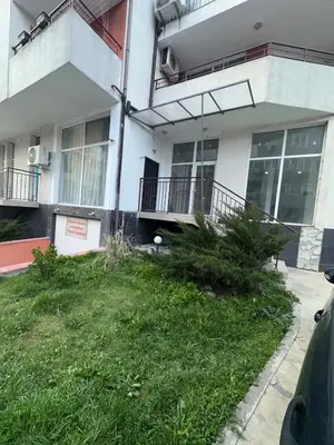 an apartment building with a yard in front of it at Апартамент за нощувки и отдих in Burgas City