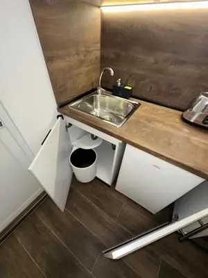 a small kitchen with a sink and a counter at Апартамент за нощувки и отдих in Burgas City