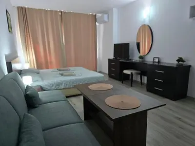 a living room with a couch and a bed at Sarafovo ATLANTIS 58 in Burgas City
