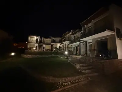 a group of houses at night with lights at Serenity Hill-Bulharsko U Nás in Sveti Vlas