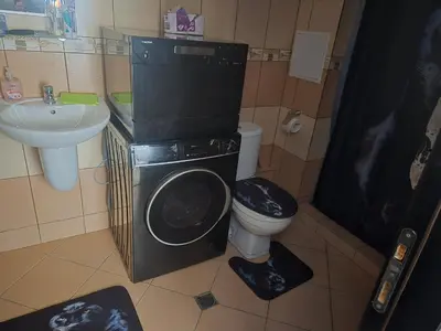 a bathroom with a washer and a toilet and a sink at Gardenia Hills in Sunny Beach