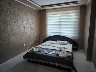 a bedroom with a bed with shoes on it at Small Central Flat - Walk to Station & Cathedral in Varna City