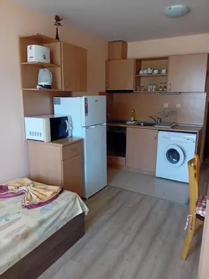 a kitchen with a refrigerator and a washing machine at Двустаен апартамент във Виго Панорама Несебър in Nesebar