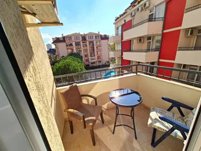 a balcony with a table and chairs and a table at complex Rose Residence Studio in Sunny Beach