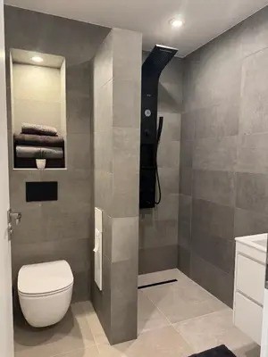 a bathroom with a toilet and a sink at Apartment Victoria in Kraymorie