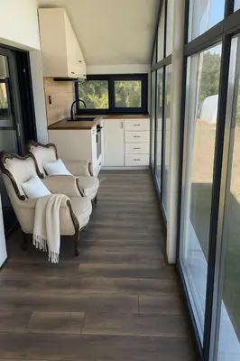 a living room with couches and windows in a house at Sea Sky House in Varna City