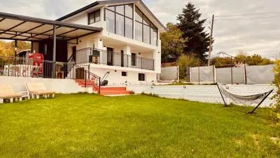 a house with a lawn in front of it at Sea Sky House in Varna City