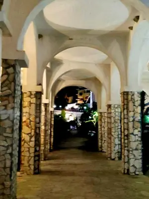an archway of a building with columns and a tunnel at Pecani Perla Del Mar - Coastal Art Residence in Sveti Vlas