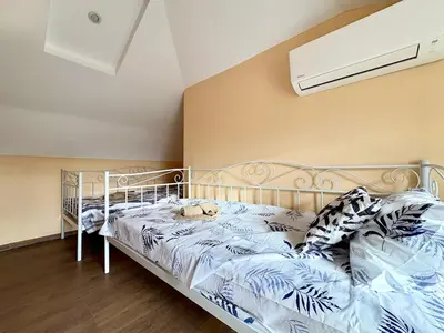 a bedroom with a bed with a white bed frame at Varna Thermae Loft in Varna City