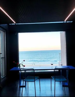 a dining room with a view of the ocean at Seafront Luxury Studio with Panoramic Sea View, Sunny Beach in Sunny Beach