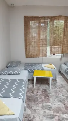a living room with two beds and a table at Стая лидер хаус in Varna City