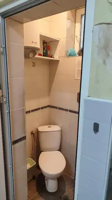 a bathroom with a toilet in a small room at Стая лидер хаус in Varna City