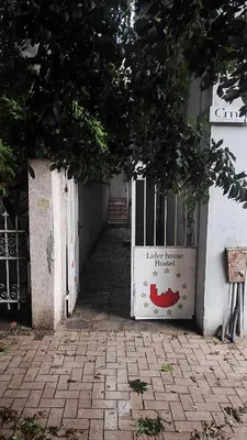 an open gate to a building with a sign on it at Стая лидер хаус in Varna City