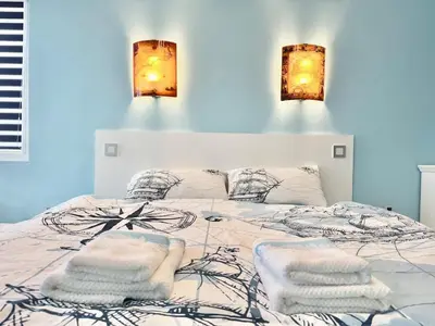 a bedroom with a bed with towels on it at SeaSky SmartHome-Penthouse with private Parking in Burgas City