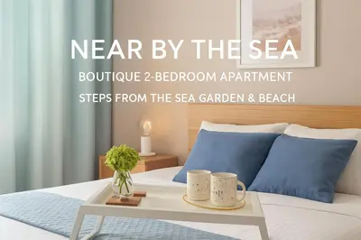 a bed with a table with two mugs on it at Nearby the Sea- Elegant Retreat in Varna in Varna City