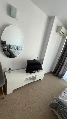 a white room with a mirror and a white table at Atlantis Resort in Burgas City
