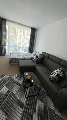 a living room with a couch and a bed at Atlantis Resort in Burgas City
