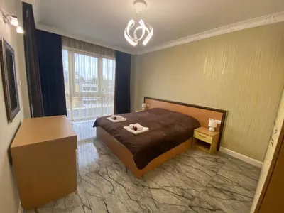 a bedroom with a bed with two towels on it at Sol e Mar Deluxe Apartment in Sunny Beach