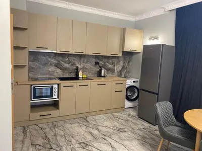 a kitchen with a refrigerator and a microwave at Sol e Mar Deluxe Apartment in Sunny Beach