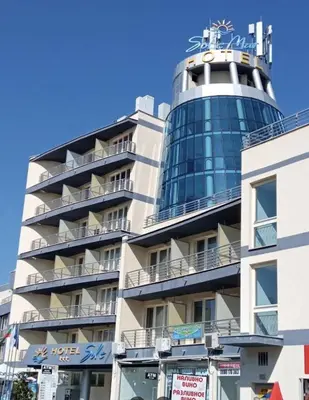 a building with a clock tower on top of it at Sol e Mar Deluxe Apartment in Sunny Beach