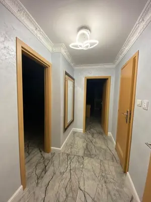 a hallway with marble floors and a ceiling at Sol e Mar Deluxe Apartment in Sunny Beach
