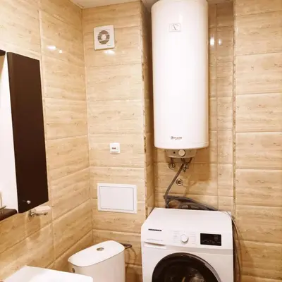 a small bathroom with a washer and dryer in it at Apartment on the Beach in Sveti Vlas
