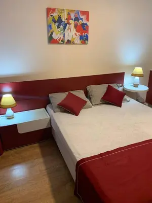 a bedroom with two beds with red and white sheets at Apartment on the Beach in Sveti Vlas