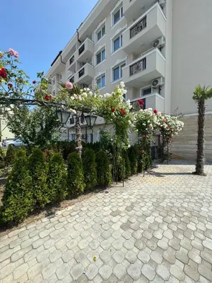 a building with flowers and plants in front of it at Студия Магнолия 6, Солнечный берег Болгария in Sunny Beach