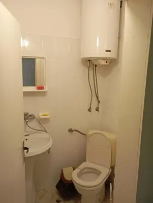 a small bathroom with a toilet and a sink at Апартамент планина in Varna City