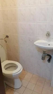 a bathroom with a toilet and a sink at Апартамент център in Varna City