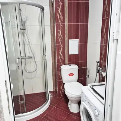 a bathroom with a shower and a toilet and a sink at Paradise in Burgas City