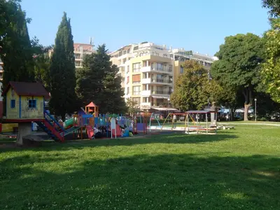 a park with a playground in the grass at Black Sea Panorama Apartment in Nesebar