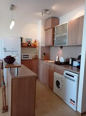 a kitchen with a washing machine and a washer at Black Sea Panorama Apartment in Nesebar