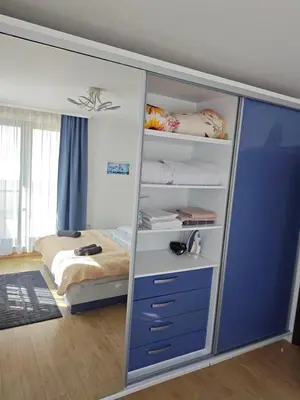 a bedroom with a closet with a bed in it at Trend Apart in Burgas City