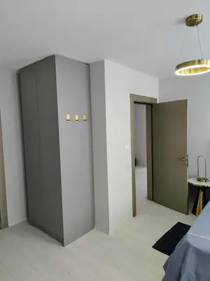 a bedroom with gray cabinets and a room with two doors at J'Adore Secret Garden, Deluxe Apartment in Sunny Beach