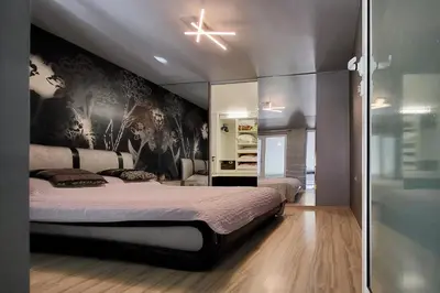 a bedroom with a large bed with a wall mural at Комфорт и стиль - Апартамент с панорамой города in Burgas City
