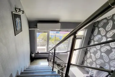 a staircase in a building with a window at Комфорт и стиль - Апартамент с панорамой города in Burgas City