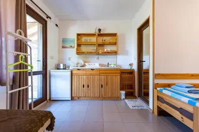a kitchen with a sink and a refrigerator at Бунгала Гнездото Bungalows The Nest Lozenets 2 in Lozenets