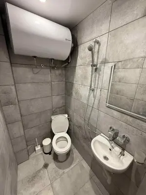 a small bathroom with a toilet and a sink at Sun in Varna City