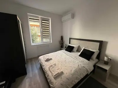 a bedroom with a bed and a window at Sun in Varna City