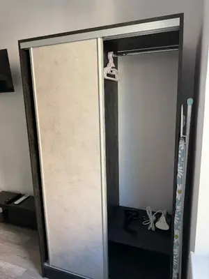 a sliding glass door with a pair of shoes on it at Sun in Varna City
