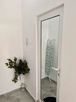a door leading into a room with a mirror at Sky in Varna City